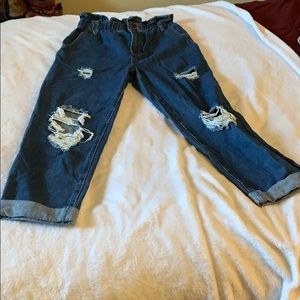 High waisted, dark denim jeans.